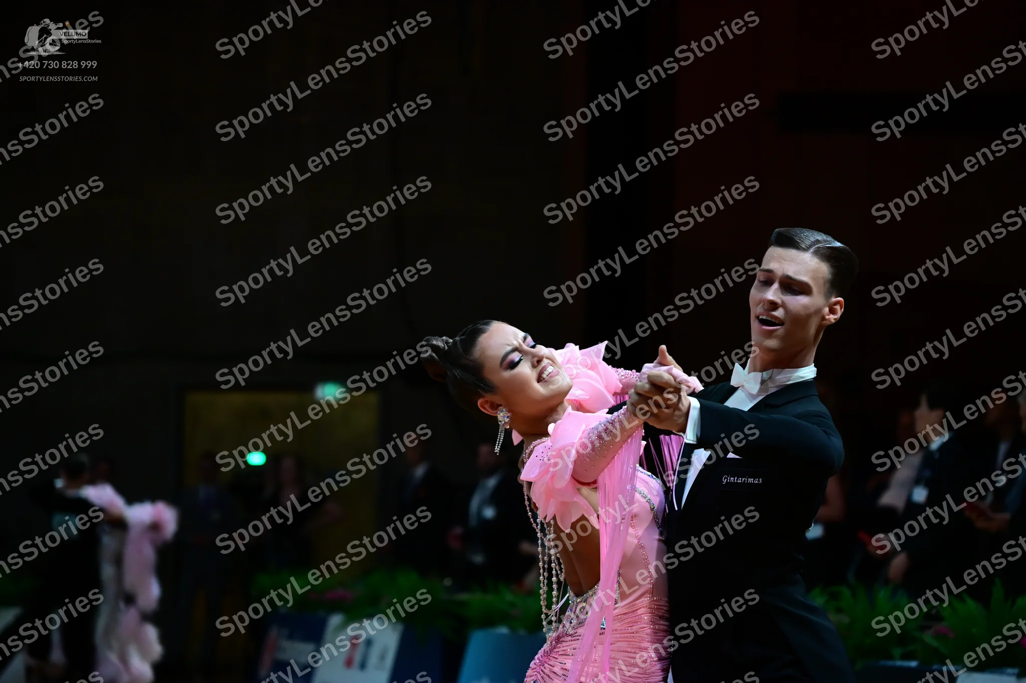 Dancesport competitor: Male dancer: black ballroom suit with a white shirt and white bow tie