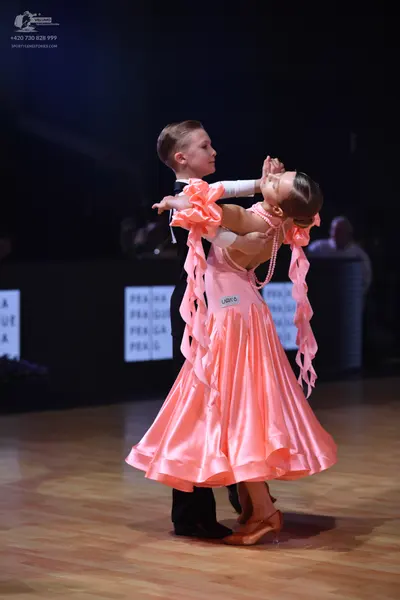 Dancesport competitor: Male dancer: black suit with a white shirt and black bow tie