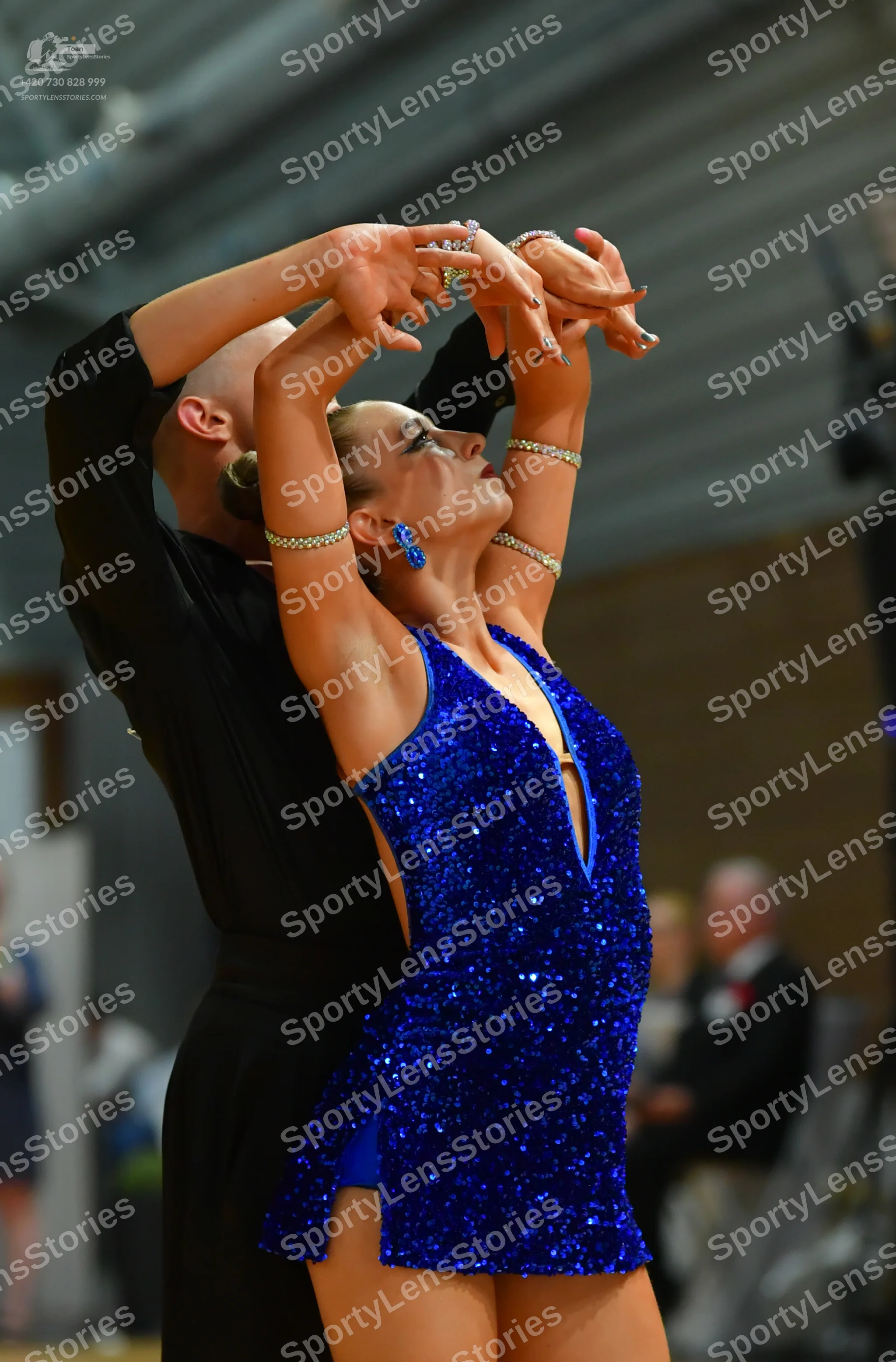 Dancesport competitor: Female:** Red latin dress with fringe