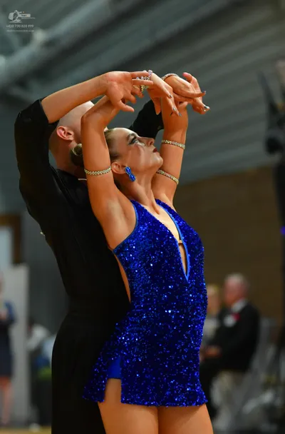 Dancesport competitor: Female:** Red latin dress with fringe