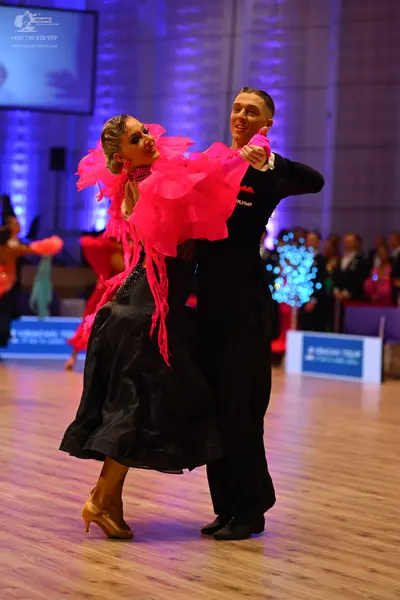 Dancesport competitor: Male dancer: black long-sleeved top and black trousers