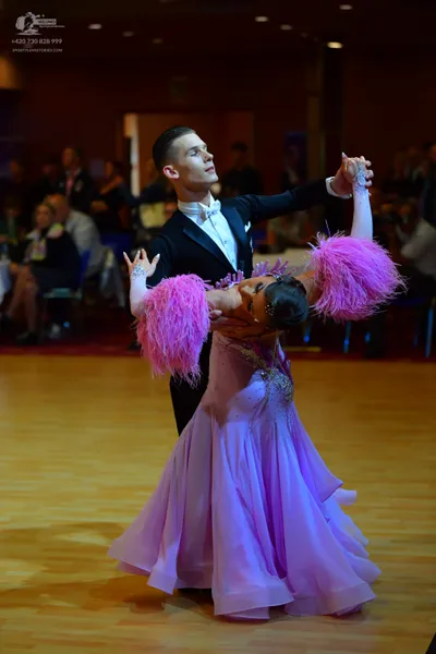 Dancesport competitor: Male dancer: black suit with a white shirt and white bowtie