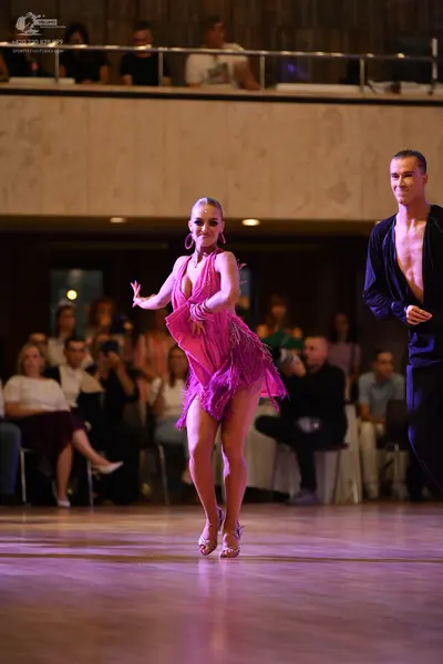 Dancesport competitor #8285: ** Red Latin dress
*   **Color:** Deep red
*   **Fabric:** Satin, with pink frin
