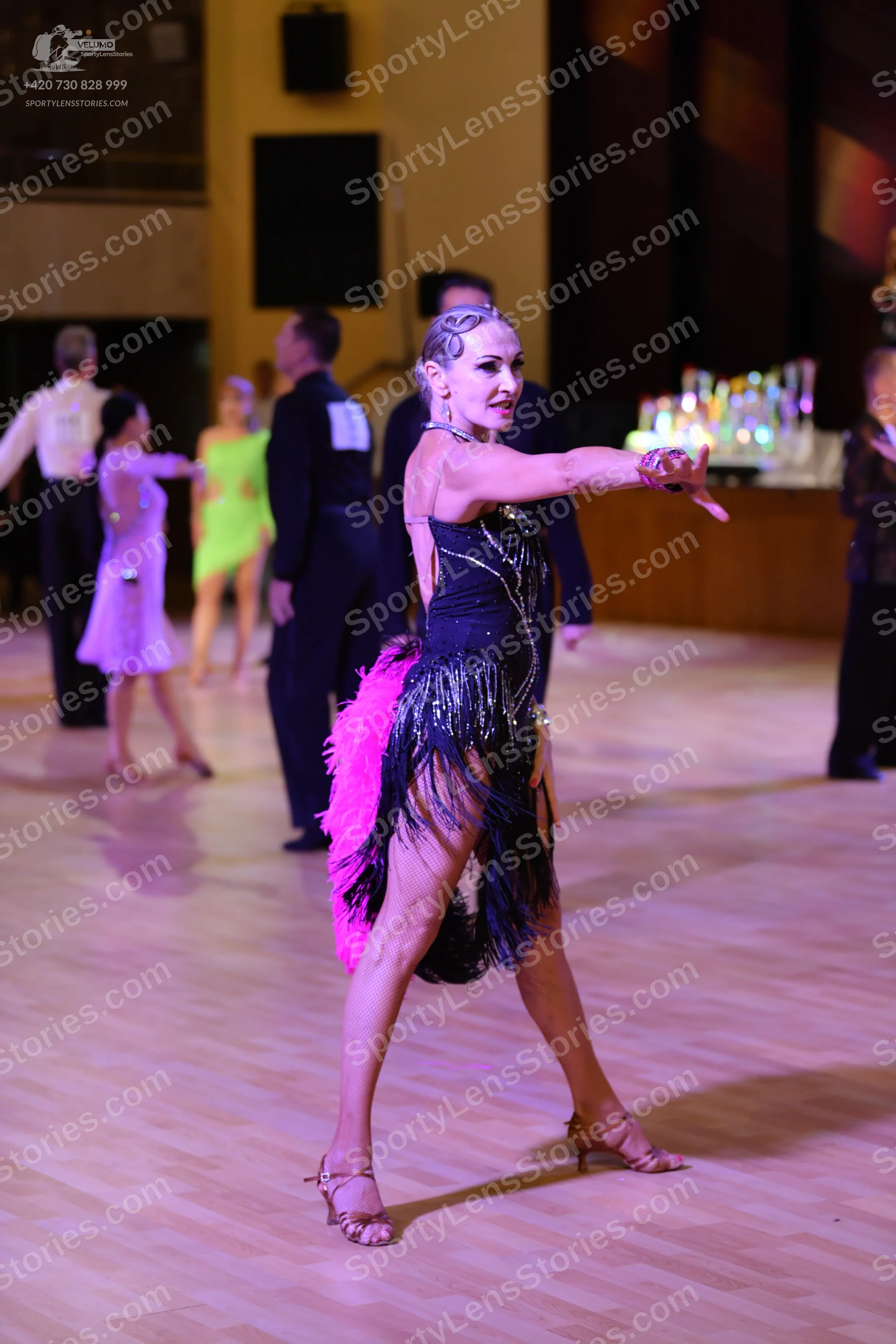 Dancesport competitor: ** Red Latin Dress
*   **Fabric:** Satin (appears to be a shiny satin)
*   **Sty