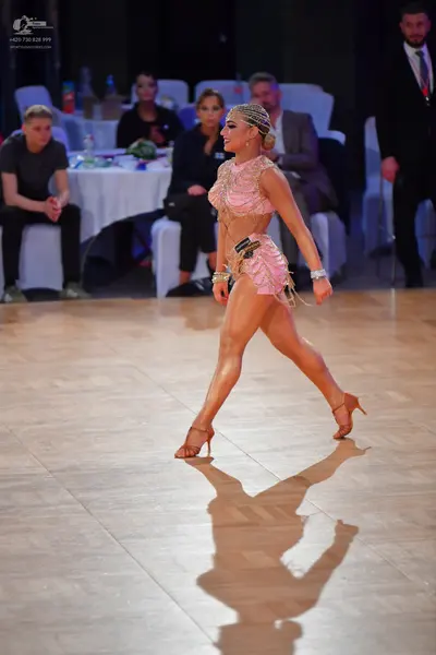 Dancesport competitor: Female dancer: nude or light pink Latin dance costume with sequin or crystal emb