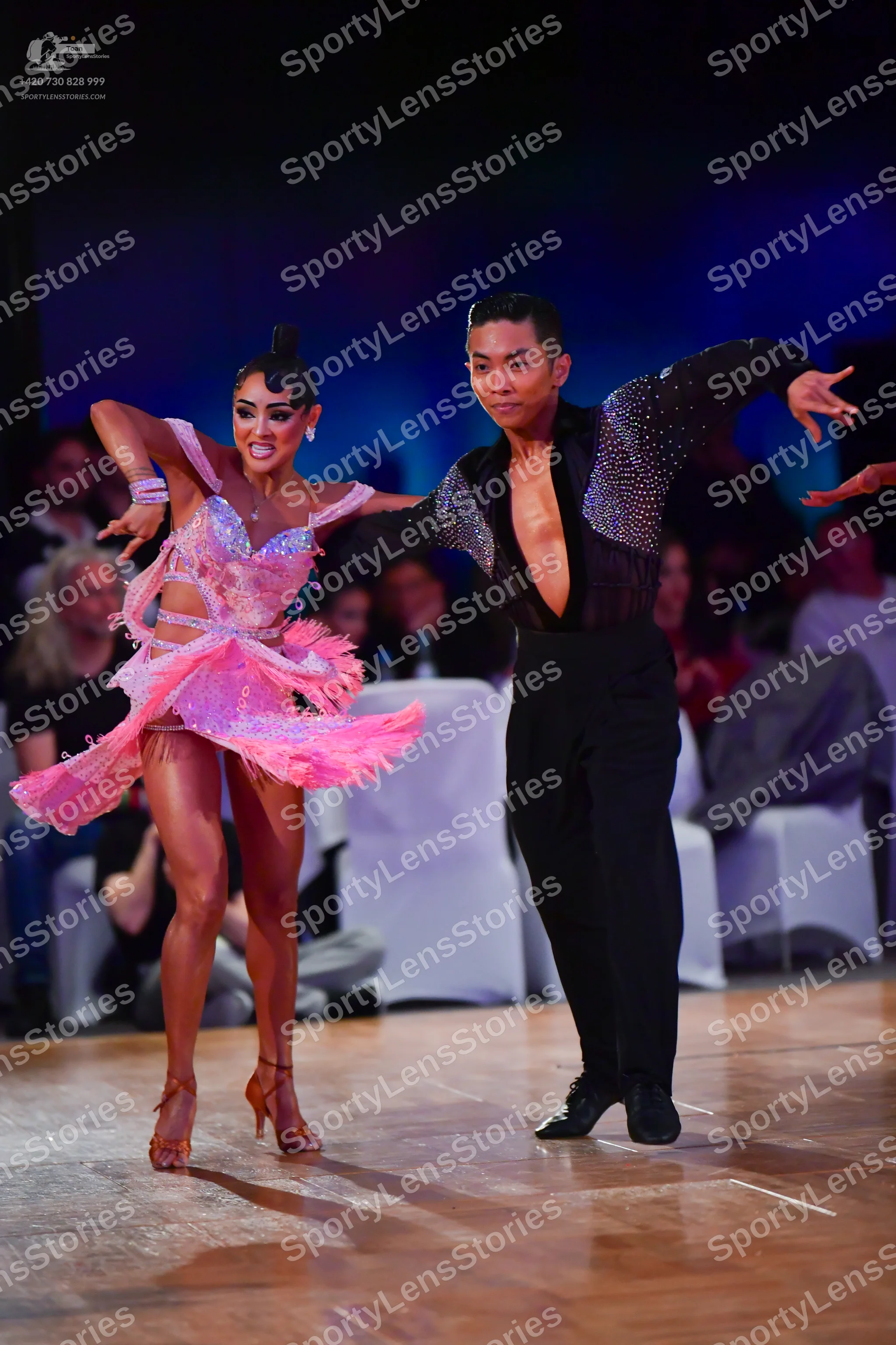 Dancesport competitor: Female dancer: pink latin dress with sequins and a layered, flared skirt