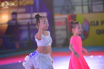 Dancesport competitor: ** White/Silver Latin Dress
*   **Color:** Primarily white with silver sequins