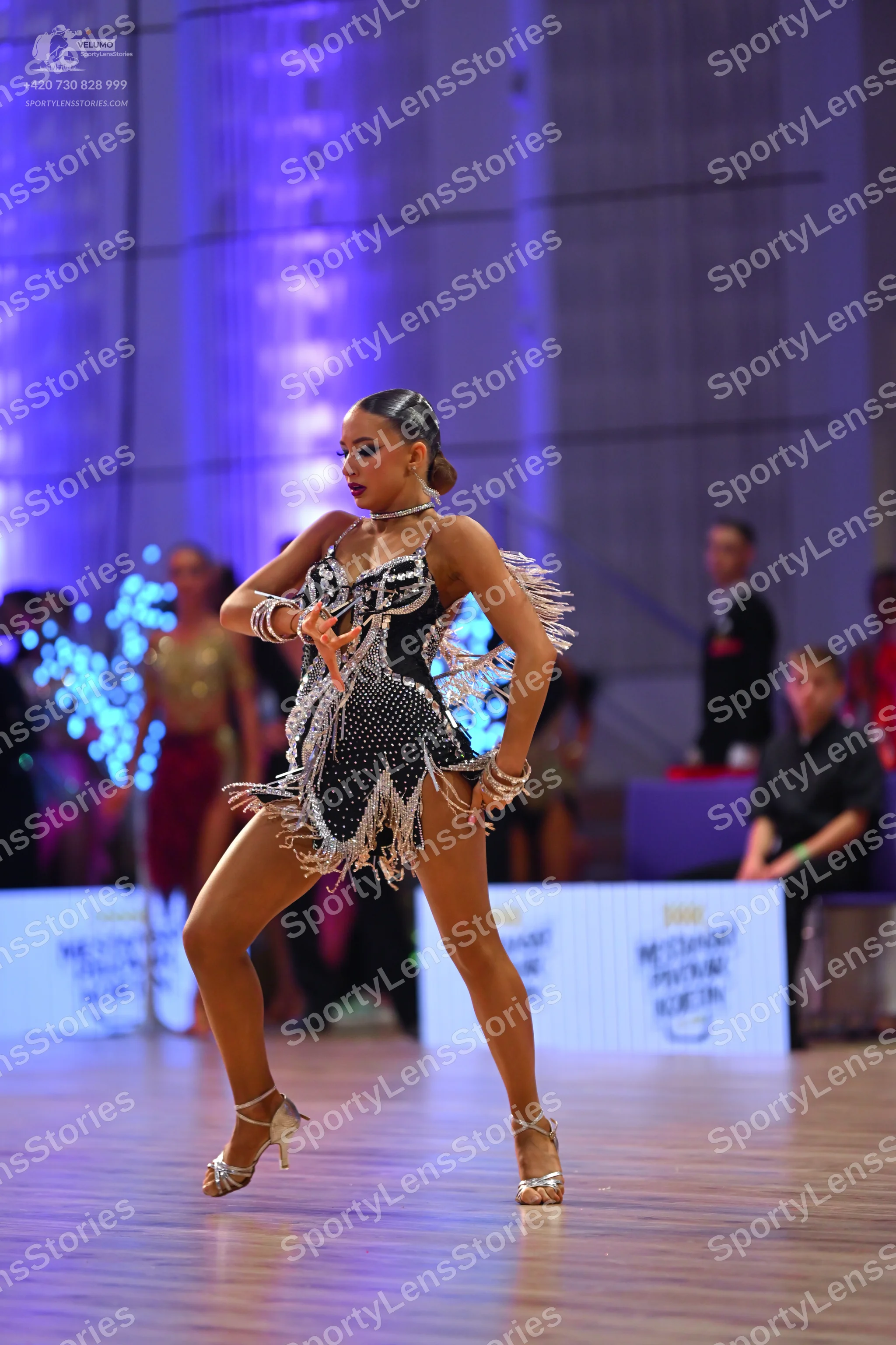 Dancesport competitor: Main female dancer: black latin dress with silver sequins and fringe, silver bra