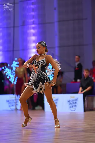 Dancesport competitor: Main female dancer: black latin dress with silver sequins and fringe, silver bra