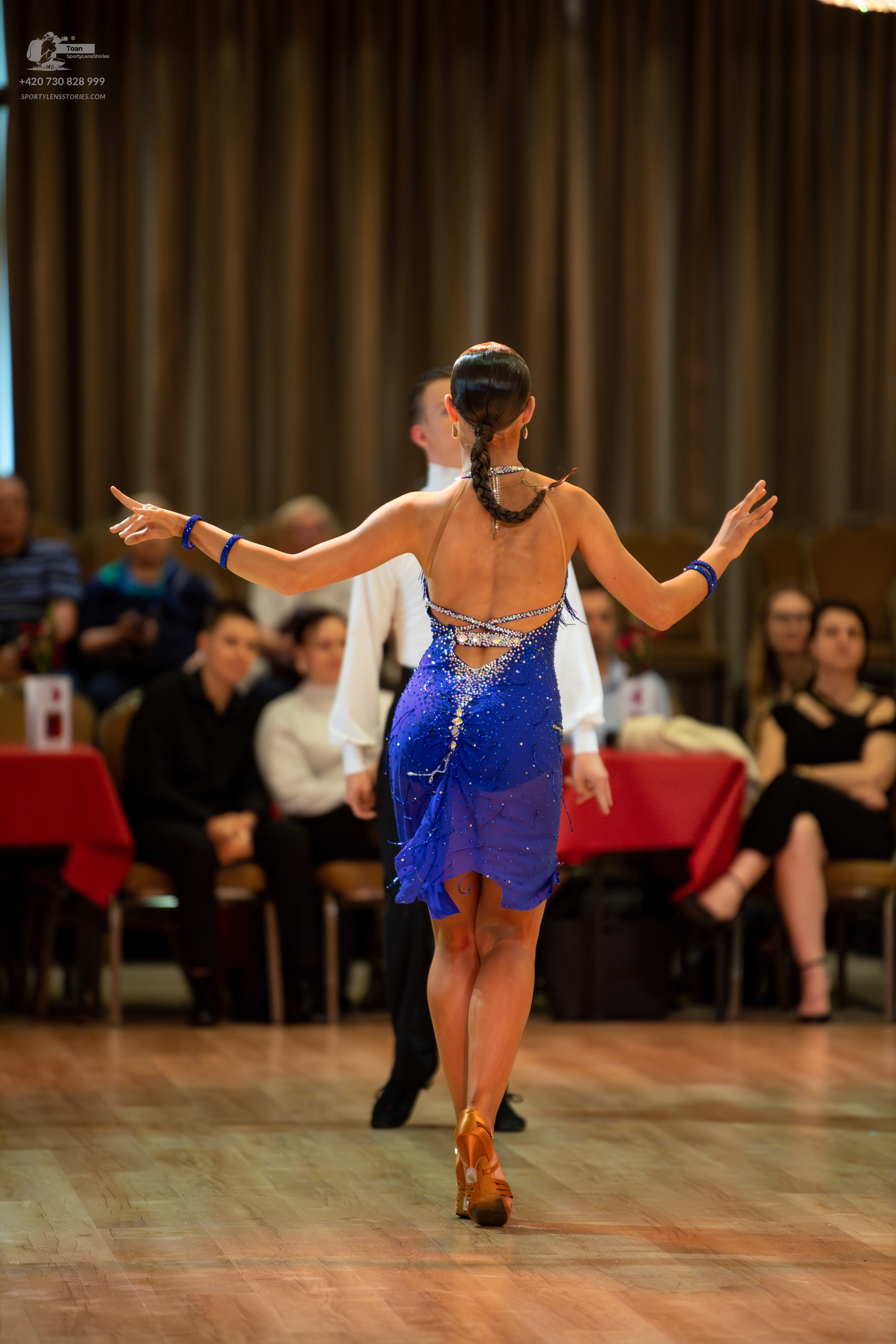 Dancesport competitor: Female dancer: blue latin dress with rhinestones and blue wristbands
