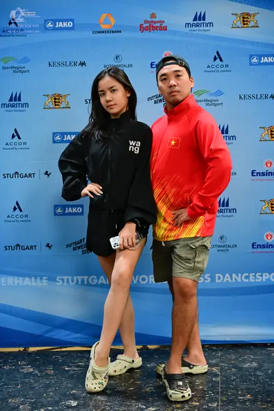 Dancesport competitor: Female dancer: black oversized sweatshirt and black shorts