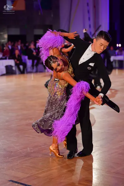 Dancesport competitor: Male dancer: black suit with white shirt and white pocket square
