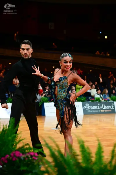 Dancesport competitor: Male dancer: black long-sleeved shirt and black trousers
