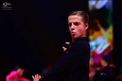 Dancesport competitor: Male dancer: black long-sleeved top