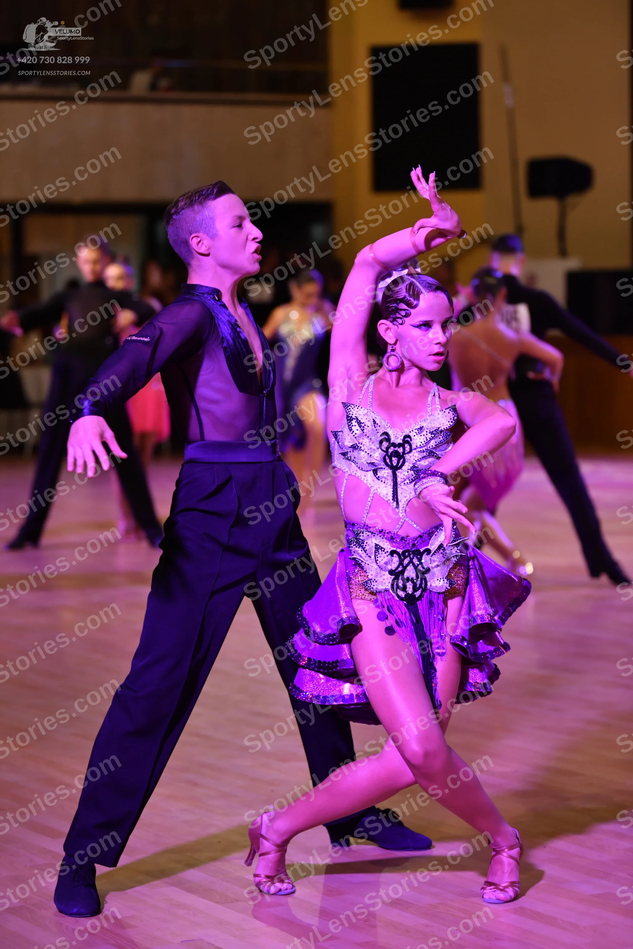 Dancesport competitor: ** Black fitted suit with silver sequin detailing on the lapels and arms
