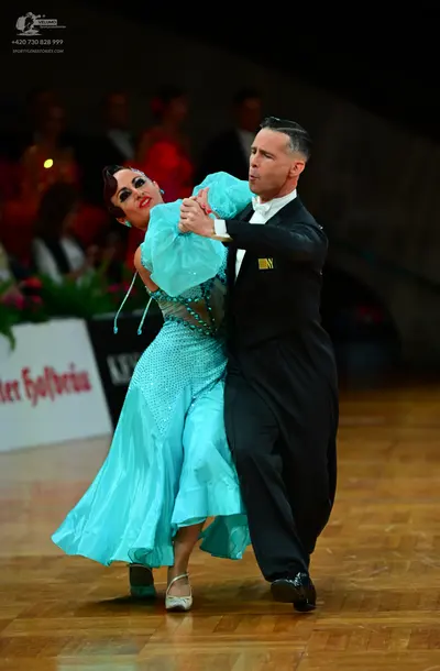 Dancesport competitor: Male dancer: black suit with a white shirt and black shoes