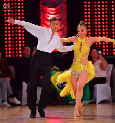 Dancesport competitor: Male dancer: white long-sleeved shirt and black trousers