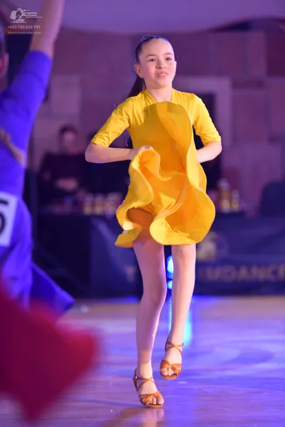 Dancesport competitor: ** Yellow
*   **Fabric:** Satin
*   **Style:** Latin Dress - A short, flowing dr