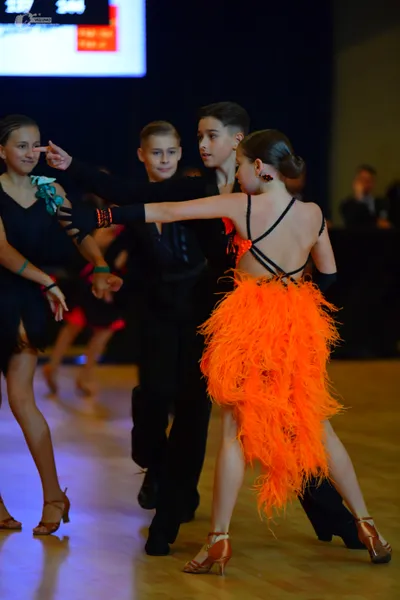 Dancesport competitor: Female dancer (left): black Latin dress