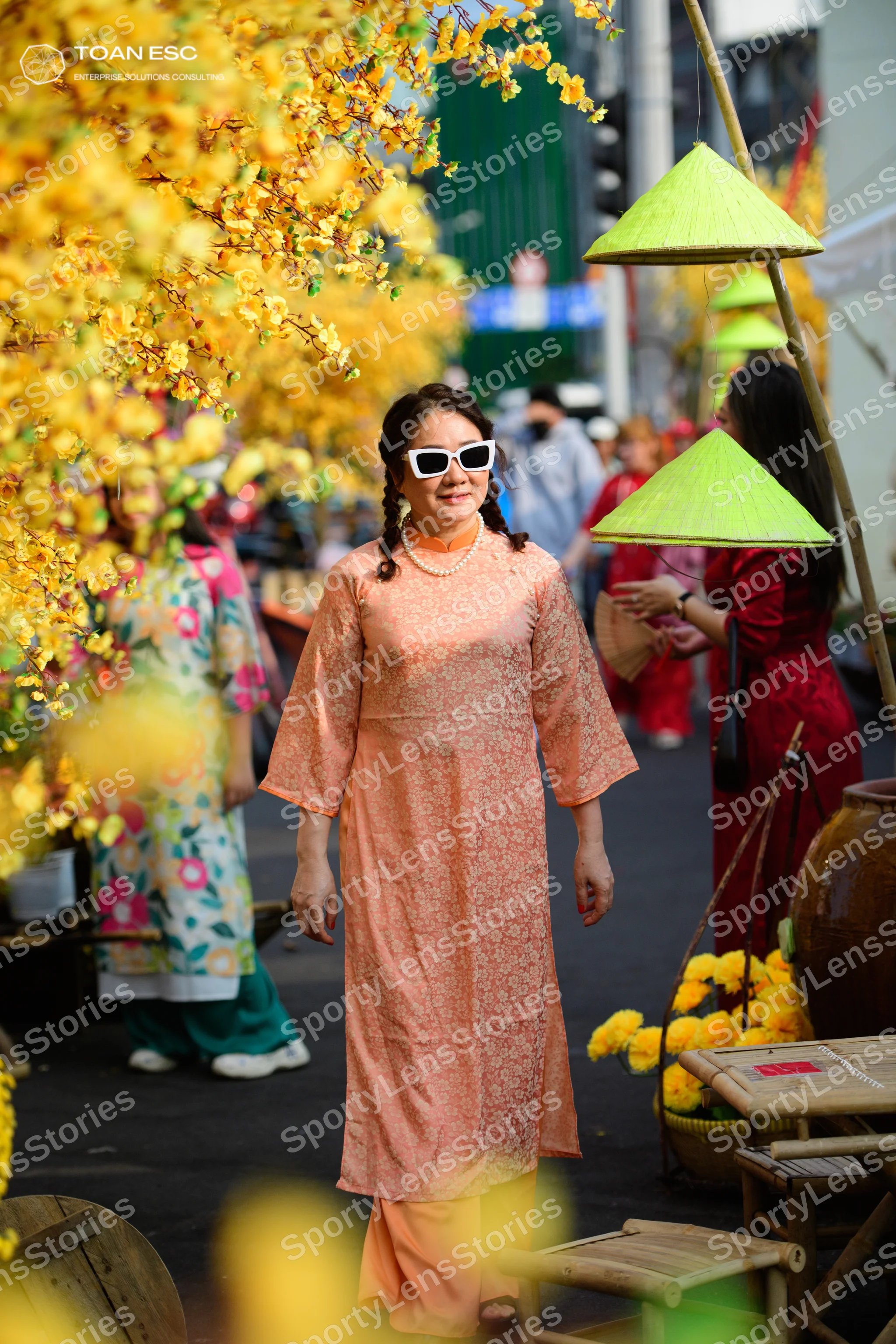 Dancesport competitor: One person in a peach-colored long-sleeved dress with a lace pattern and a pearl