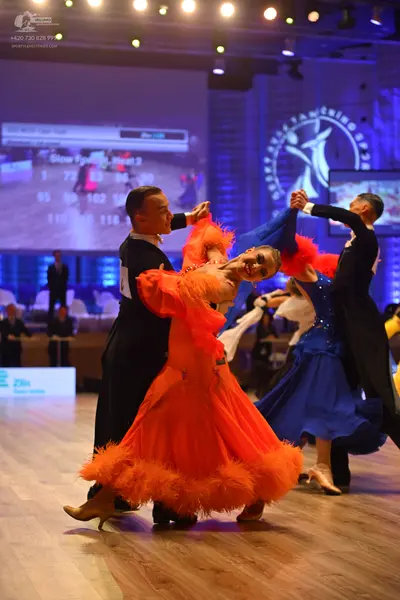 Dancesport competitor: Male dancer (left): black suit