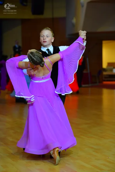 Dancesport competitor: Male dancer: white long-sleeved shirt, black waistcoat, black necktie, and black