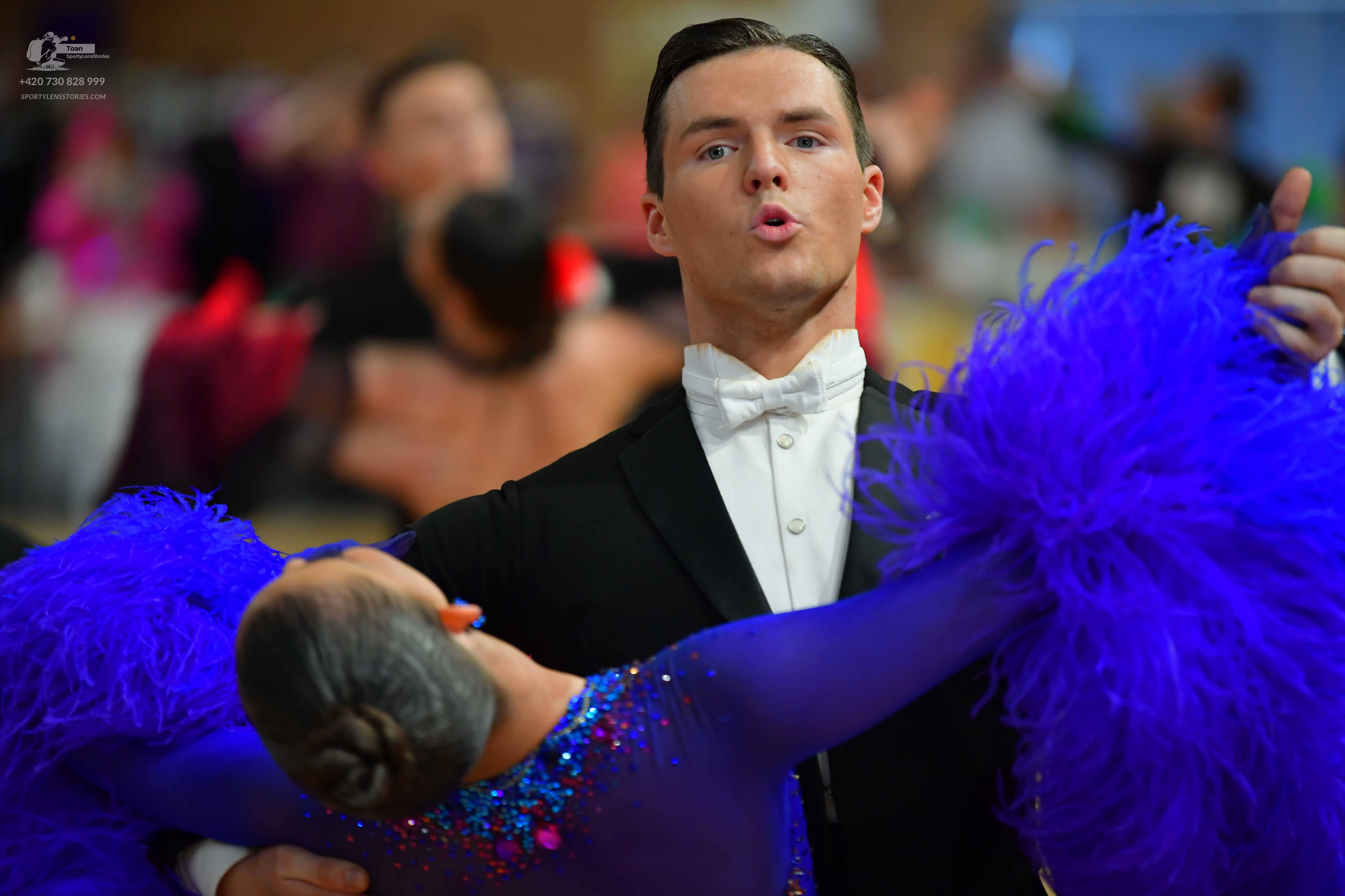 Dancesport competitor: Male:** Black tailsuit with sequin lapels and a white tuxedo shirt with a ruffle