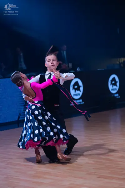 Dancesport competitor: Male dancer: white long-sleeved shirt, black waistcoat, and black trousers