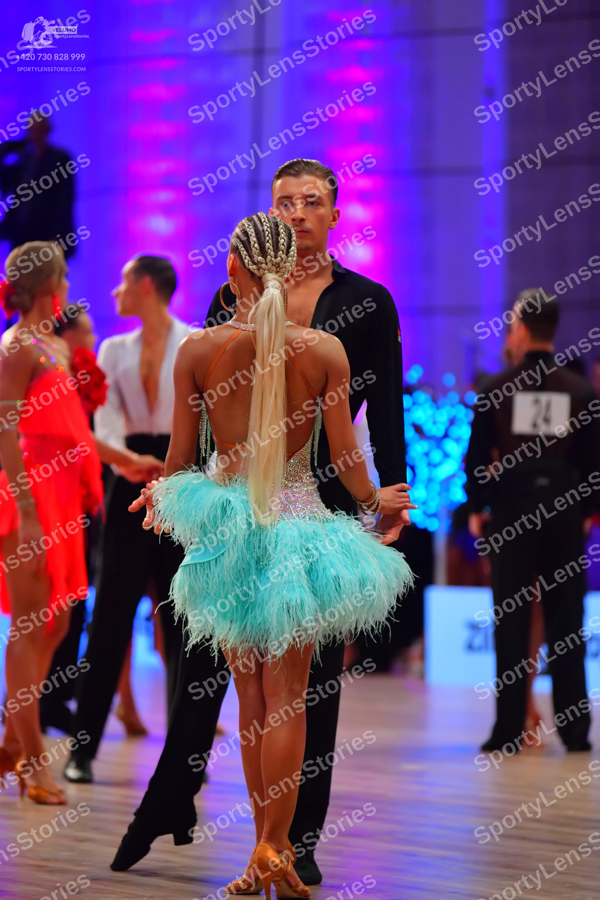 Dancesport competitor: Female dancer: light blue/aqua Latin dress with a feathery skirt