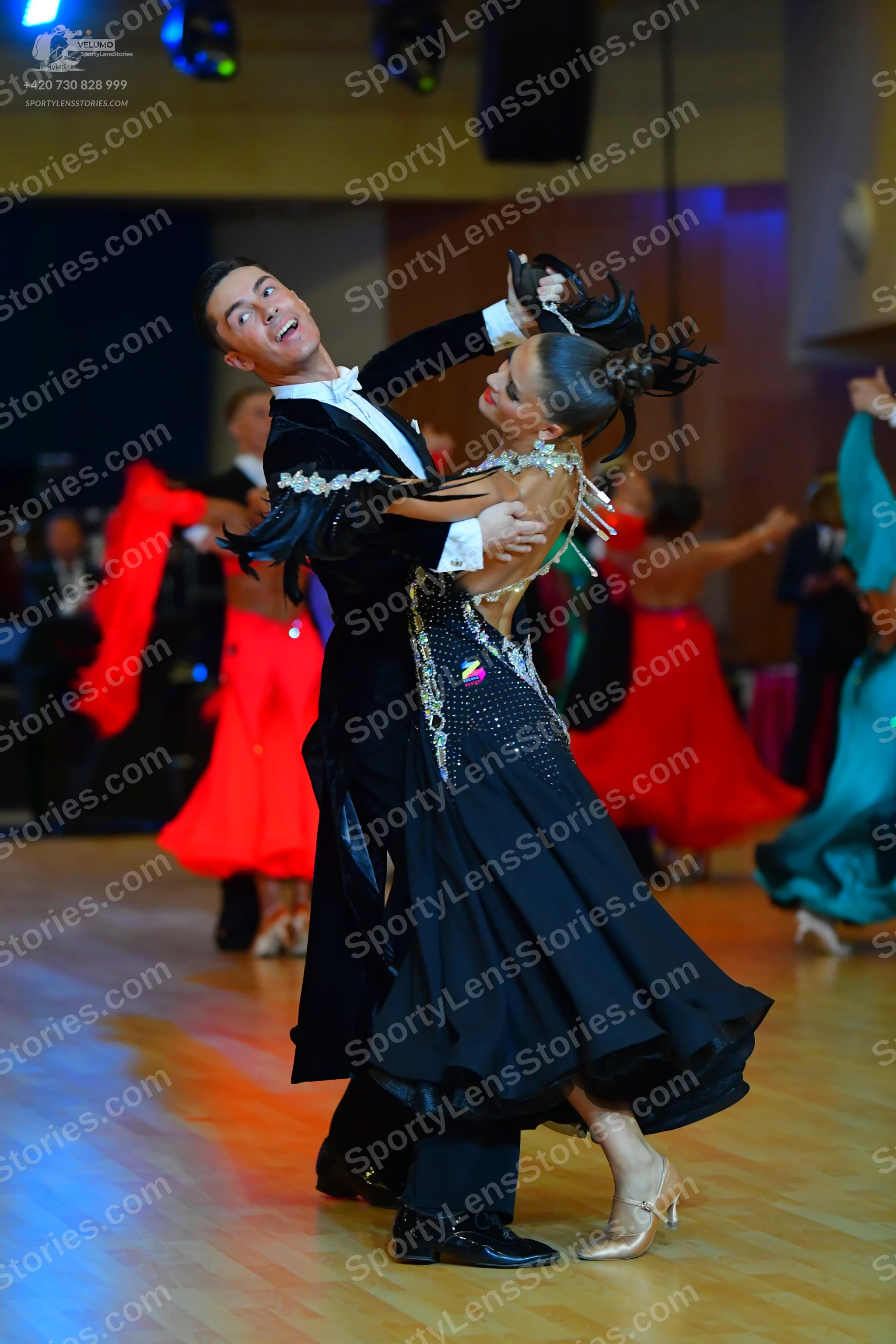 Dancesport competitor: Main male dancer: black suit with a white frilled collar and decorative white/si