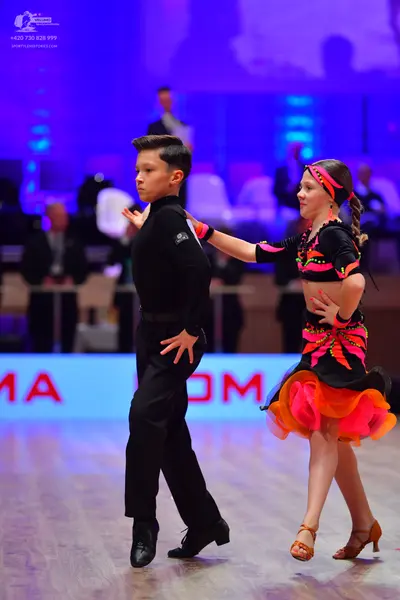 Dancesport competitor: Male dancer: black long-sleeved shirt and black trousers