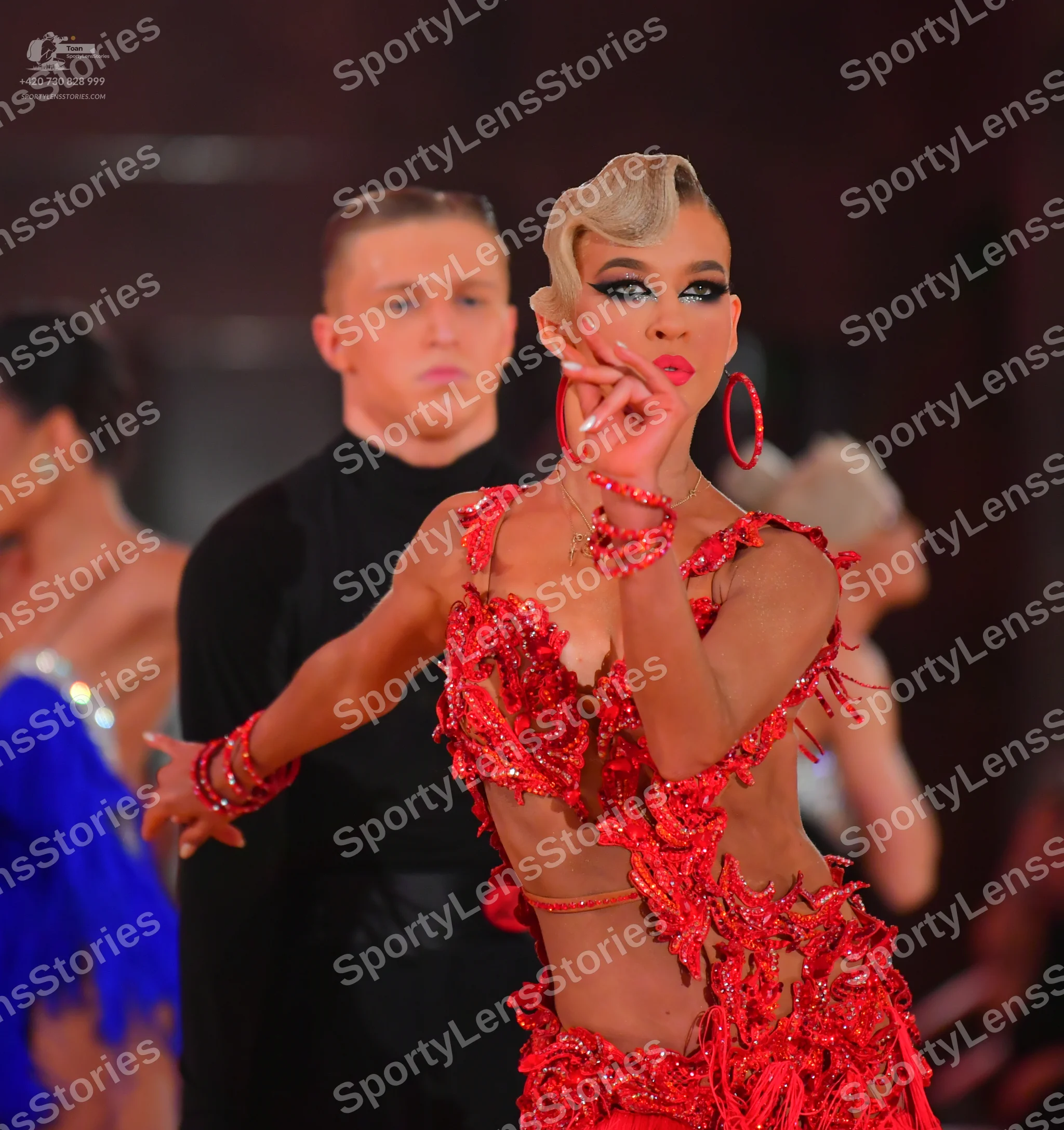 Dancesport competitor: Female dancer: red Latin dance dress with heavy red crystal and sequin embellish