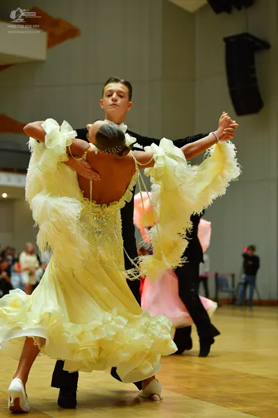 Dancesport competitor: Male dancer: black long-sleeved shirt and black trousers