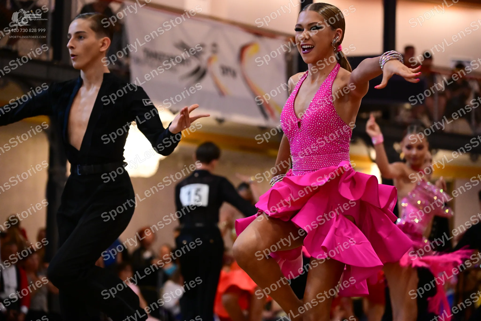 Dancesport competitor #15: Male dancer (left): black long-sleeved shirt with a deep V-neck and black trouse