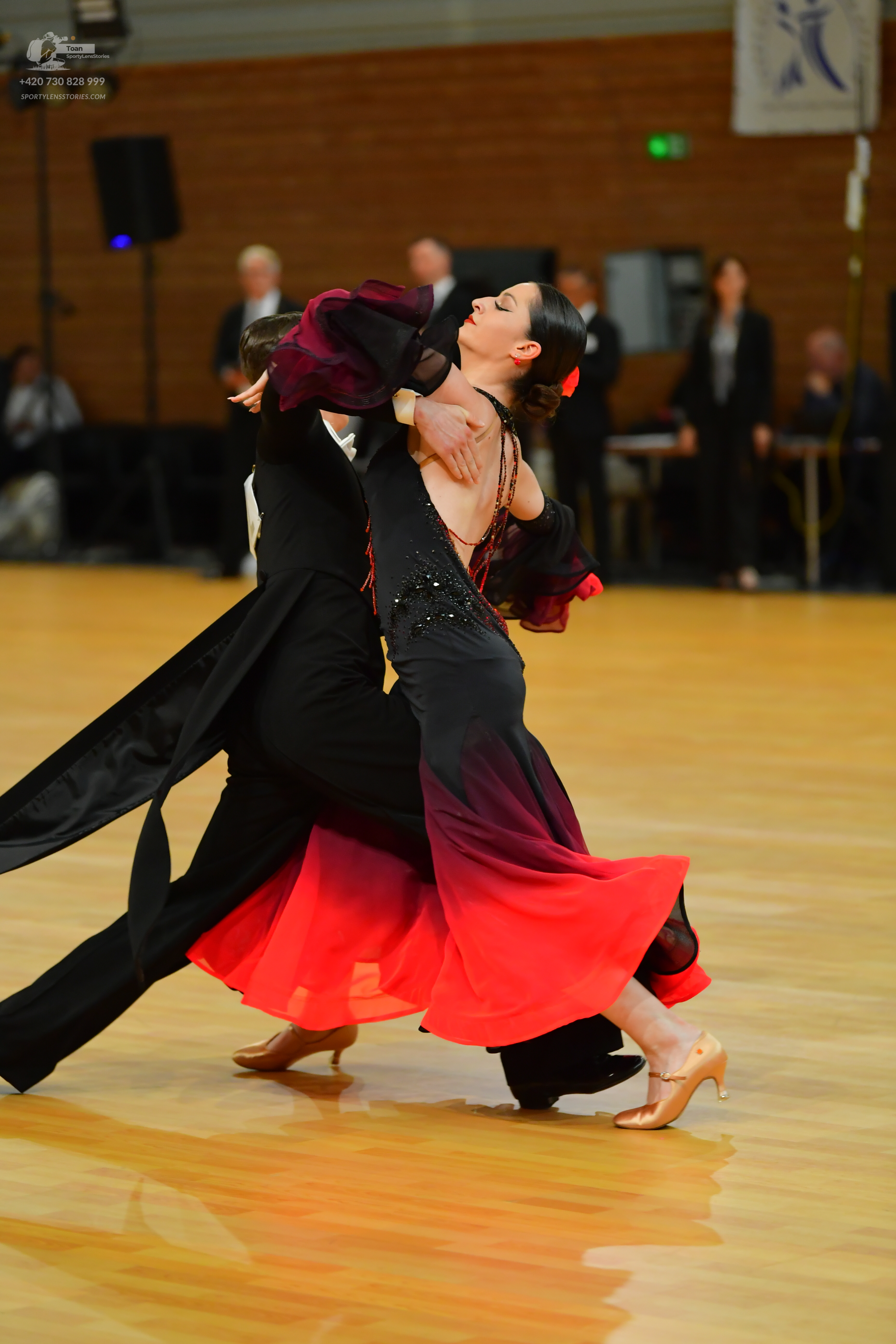 Dancesport competitor: ** Black tailsuit
*   **Fabric:** Likely satin or a similar smooth fabric, poten