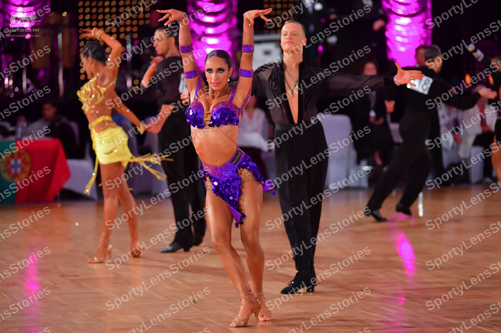Dancesport competitor #128: Female dancer (left): yellow Latin dress with gold sequins and fringe