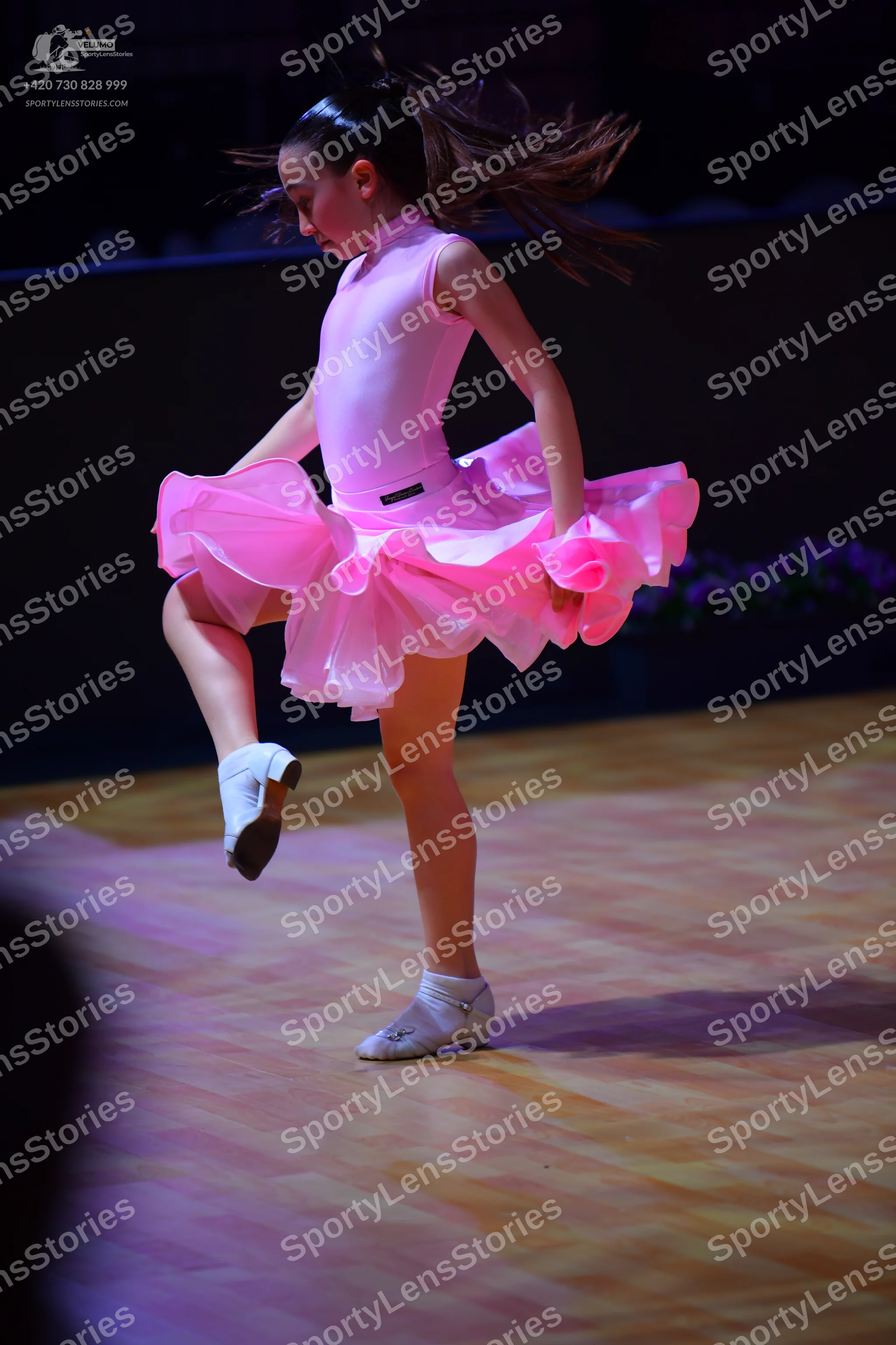 Dancesport competitor: Female dancer: light pink latin-style dress with a smooth, satin-like bodice and
