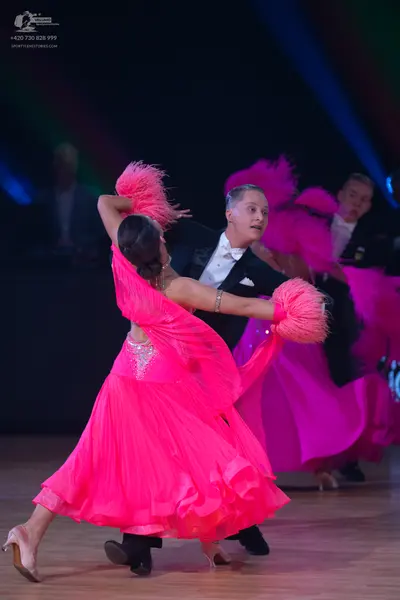 Dancesport competitor: Male dancer: black suit with a white shirt and white bow tie