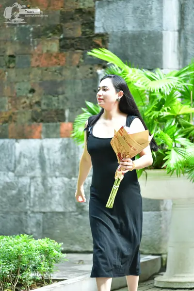 Dancesport competitor: Female dancer: black sleeveless midi dress
