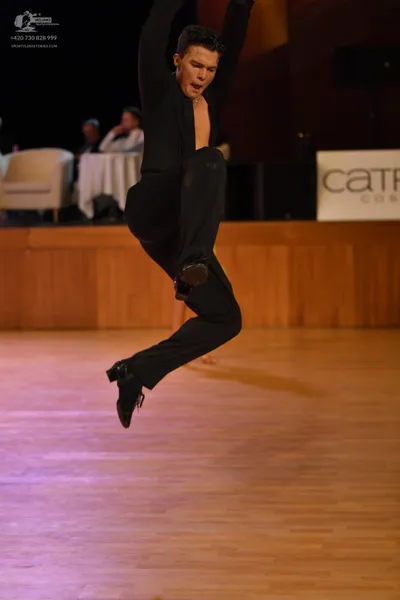 Dancesport competitor: Male dancer: black long-sleeved top and black trousers