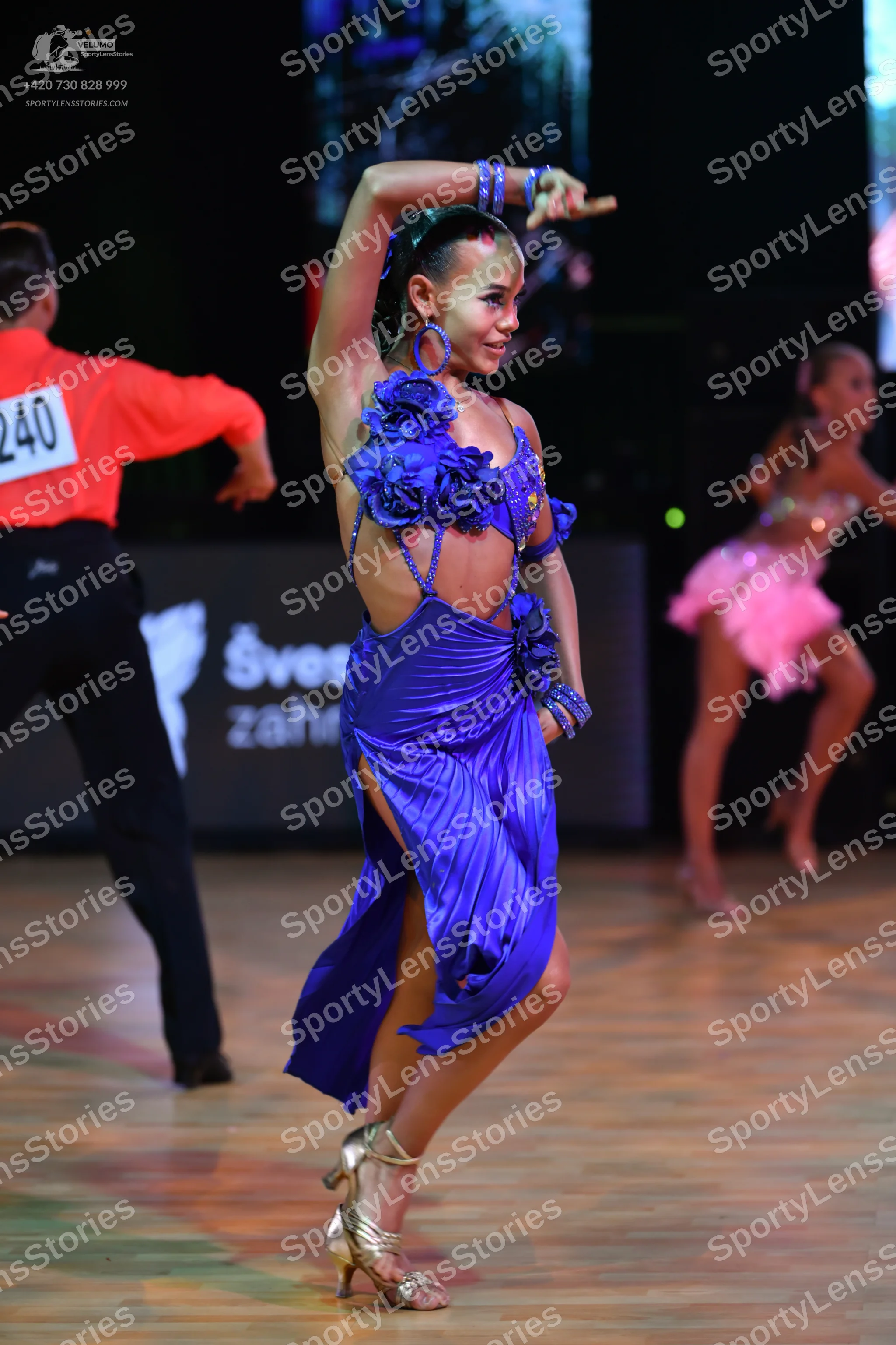 Dancesport competitor: Male dancer: coral long-sleeved shirt and black trousers