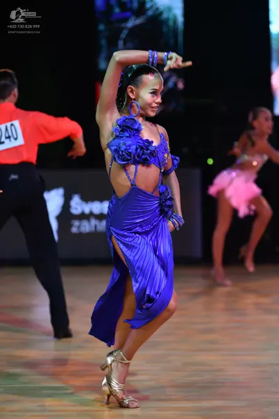 Dancesport competitor: Male dancer: coral long-sleeved shirt and black trousers