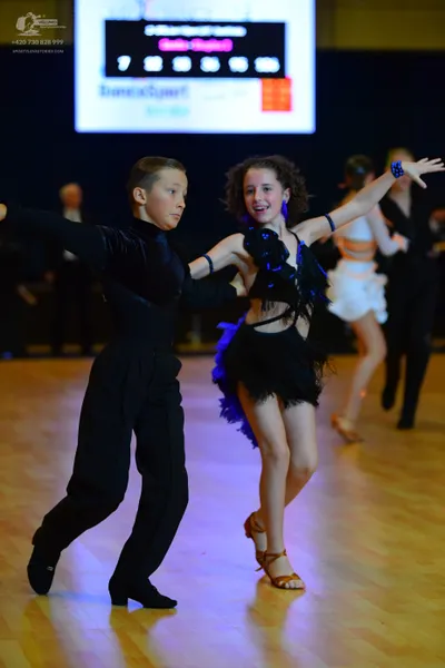 Dancesport competitor: Male dancer: black long-sleeved top and black trousers made of a smooth, slightl
