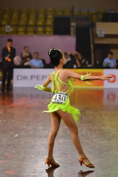 Dancesport competitor #430: Female dancer: lime green latin dress with fringe and matching wristbands