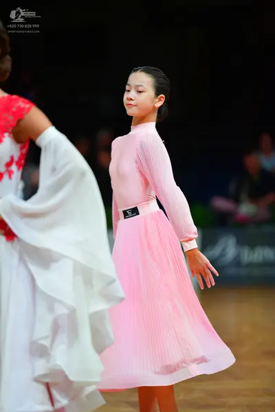 Dancesport competitor: Female dancer 1: white ballroom dress with red lace patterns