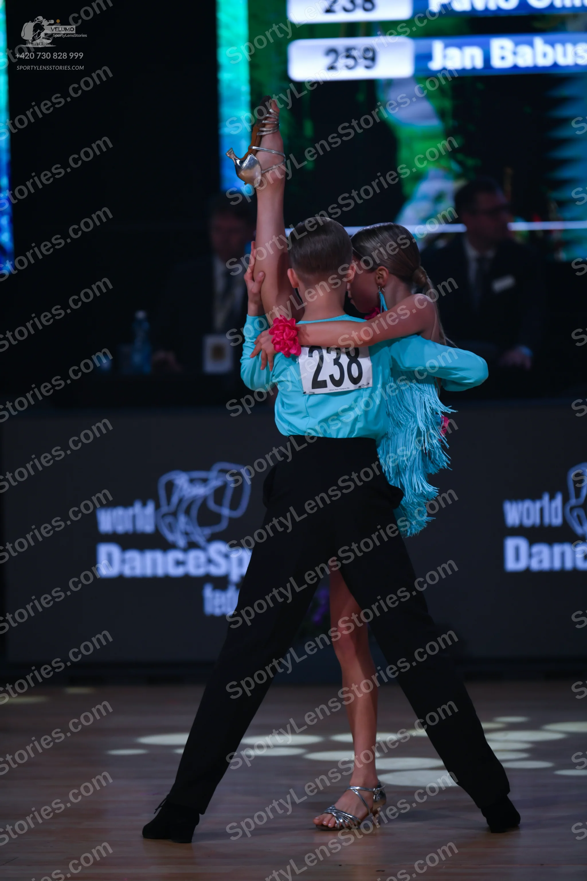 Dancesport competitor: Male dancer: light blue long-sleeved shirt and black trousers
