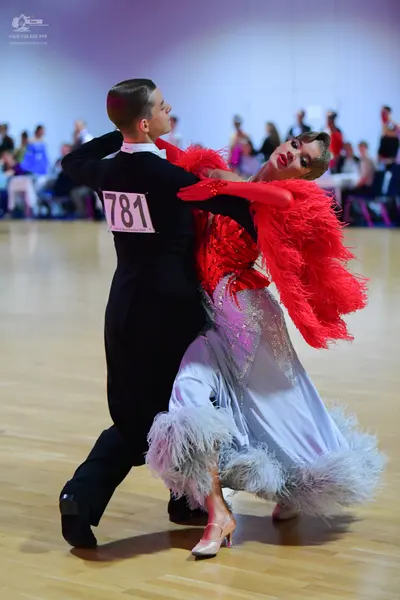 Dancesport competitor #781: Male dancer: black long-sleeved shirt with a white collar and black trousers