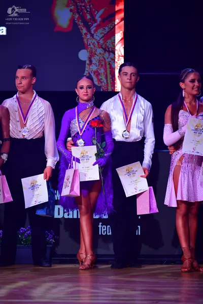 Dancesport competitor: Male dancer 1: white textured long-sleeved shirt and black trousers