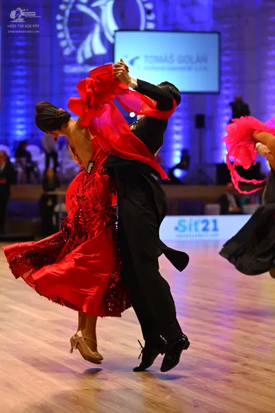 Dancesport competitor: Female dancer: red latin dress with sequins