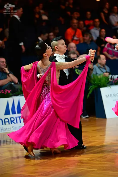 Dancesport competitor: Male dancer: black suit with a white shirt and white bow tie